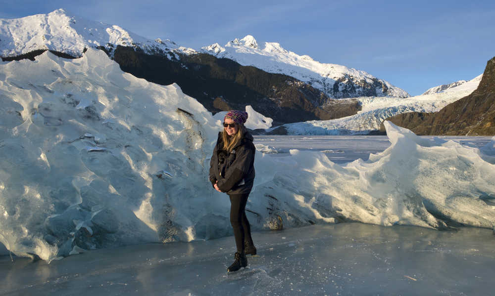 Lexi Lodwig skates with her puppy, Lola, through stranded icebergs on Mendenhall Lake on Wednesday.
