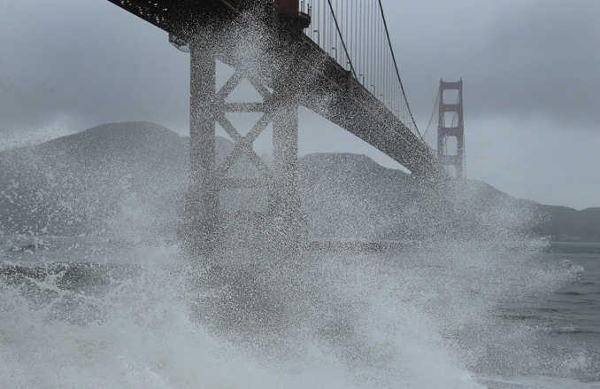 Waves churned by a winter storm break underneath the south tower of the Golden Gate Bridge on Wednesday in San Francisco Bay