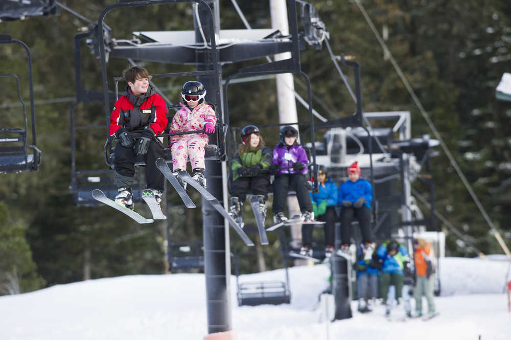 Students and instructor ride the Porcupine Chairlift as they participate in the the World's Largest Lesson at Eaglecrest on Friday as part of Learn to Ski and Snowboard Month. The event, that included 80 participants and 17 instructors, was part of a national attempt to break a Guinness World Record.