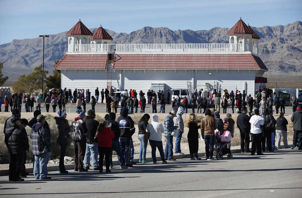 Patrons line up to buy Powerball lottery tickets outside the Primm Valley Casino Resorts Lotto Store just inside the California border Tuesday, Jan. 12, 2016, near Primm, Nev. The Powerball jackpot has grown to over 1 billion dollars for the next drawing on Wednesday. (AP Photo/John Locher)
