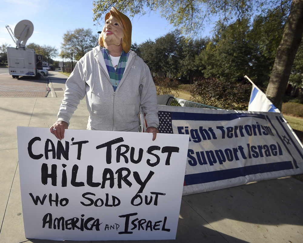 Bob Kunst, of Miami Beach, Fla., wears a Hillary Clinton as he stands outside the North Charleston Coliseum, Wednesday, Jan. 13, 2016, in North Charleston, S.C., in advance of Thursday's Fox Business Network Republican presidential debate. (AP Photo/Rainier Ehrhardt)