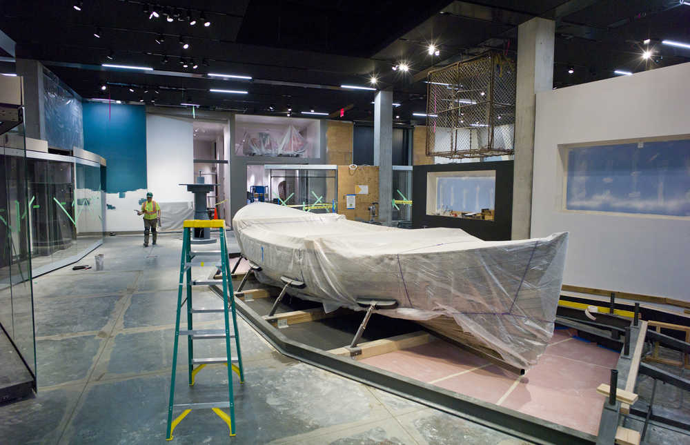 A Bristol Bay double-ender fishing boat is shrouded in a sheet of protective plastic inside the permanent gallery under construction at the Alaska State Library, Archives, and Museums building.
