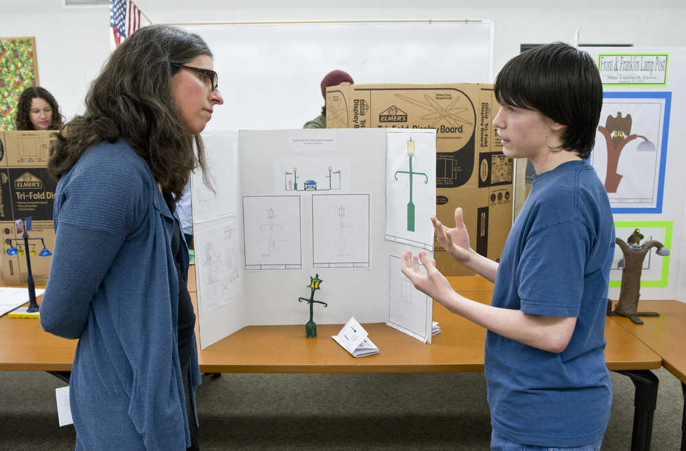 Freshman Elijah Rodriguez explains his design and lighting concept to Michele Elfers, a project manager for the City & Borough of Juneau, as part of his computer aided design class presentation at Juneau-Douglas High School on Thursday. Teacher Colin Dukes says students are given real world problems to work on and looks to city projects, such as the Franklin and Front Street reconstruction project, for student projects.
