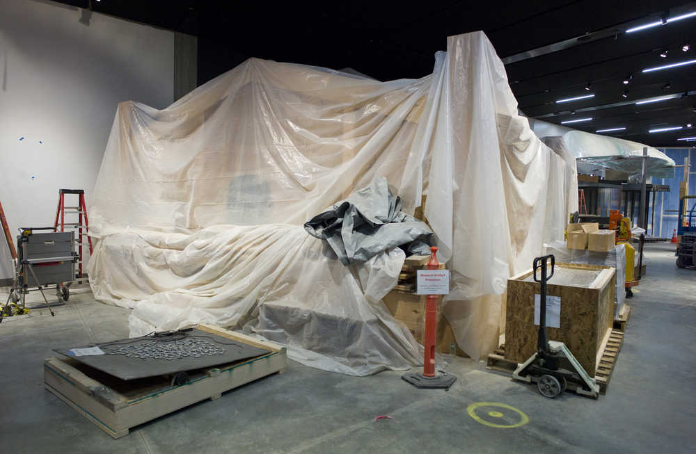A clan house is shourded in a sheet of protective plastic inside the permanent gallery under construction at the Alaska State Library, Archives, and Museums building.