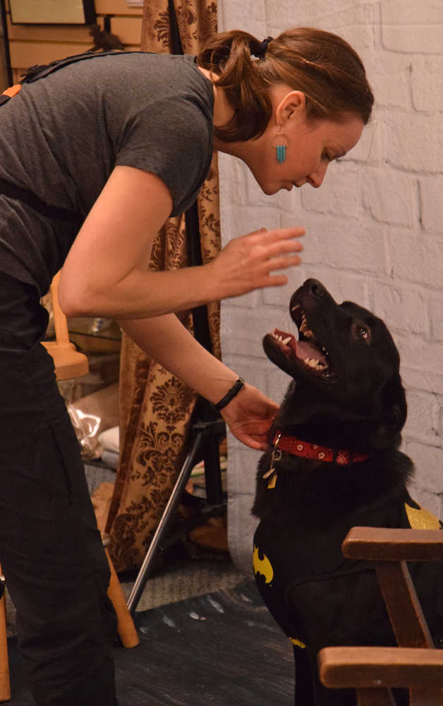 Photographer Kally Flynn talks to 10-month-old Luna, wearing a Batman costume, on Thursday, Jan. 14, 2016 during a fundraiser for the Gastineau Humane Society at Alaskan Dames.