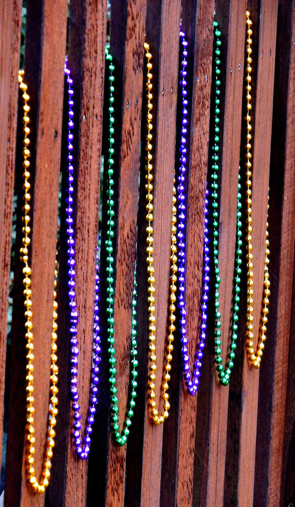 Mardi Gras beads decorate a fence, January 14, downtown Juneau.