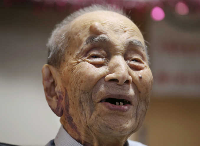 In this Aug. 21, 2015 photo, Yasutaro Koide smiles upon being formally recognized as the world's oldest man by the Guinness World Records at a nursing home in Nagoya, central Japan.