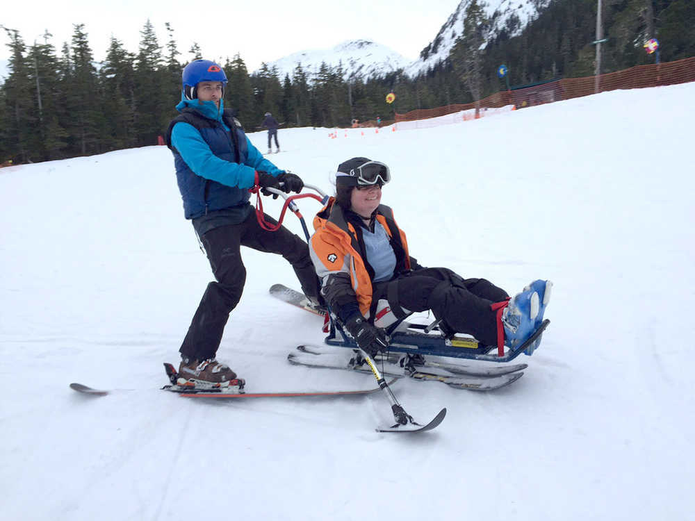 Adaptive instructor Tristan Knutson-Lombardo and Rhonnie McMaster try out adaptive ski equipment on Jan. 17, at a day SAIL's ORCA program and Eaglecrest Ski Area have organized for five years now.
