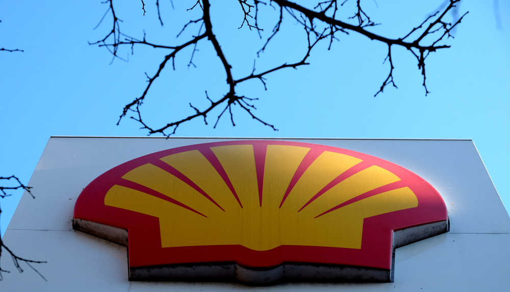 The Shell logo is seen at a petrol station in London on Wednesday. Royal Dutch Shell expects its fourth quarter profits to drop by at least 40 percent to between $1.6 billion and $1.9 billion after a sharp drop in crude oil prices.