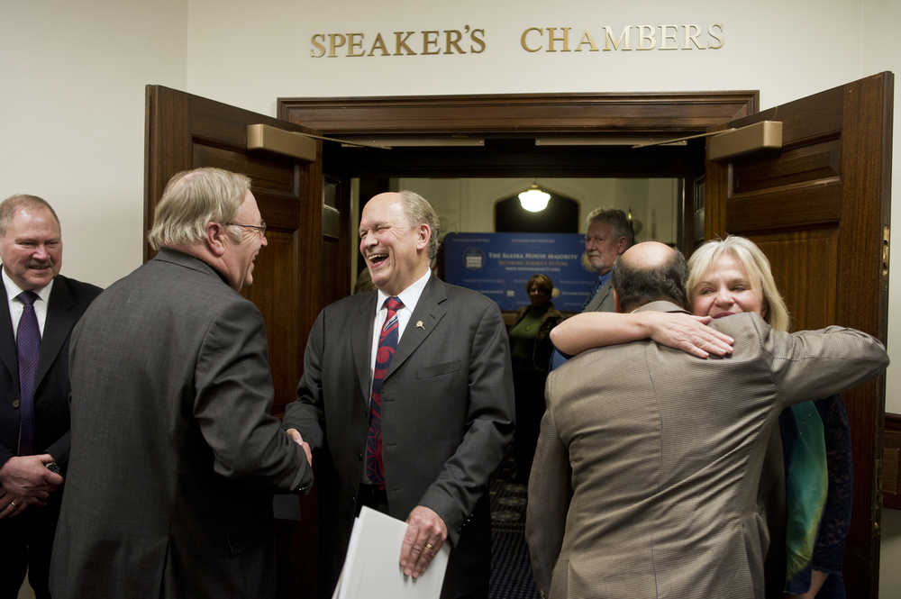 Gov. Bill Walker shakes hands with Speaker of the House Mike Chenault, R-Nikiski, after his annual State of the State address to a Joint Session of the Alaska Legislature at the Capitol on Thursday. First Lady Donna Walker, right, receives a hug by Rep. Les Gara, D-Anchorage.