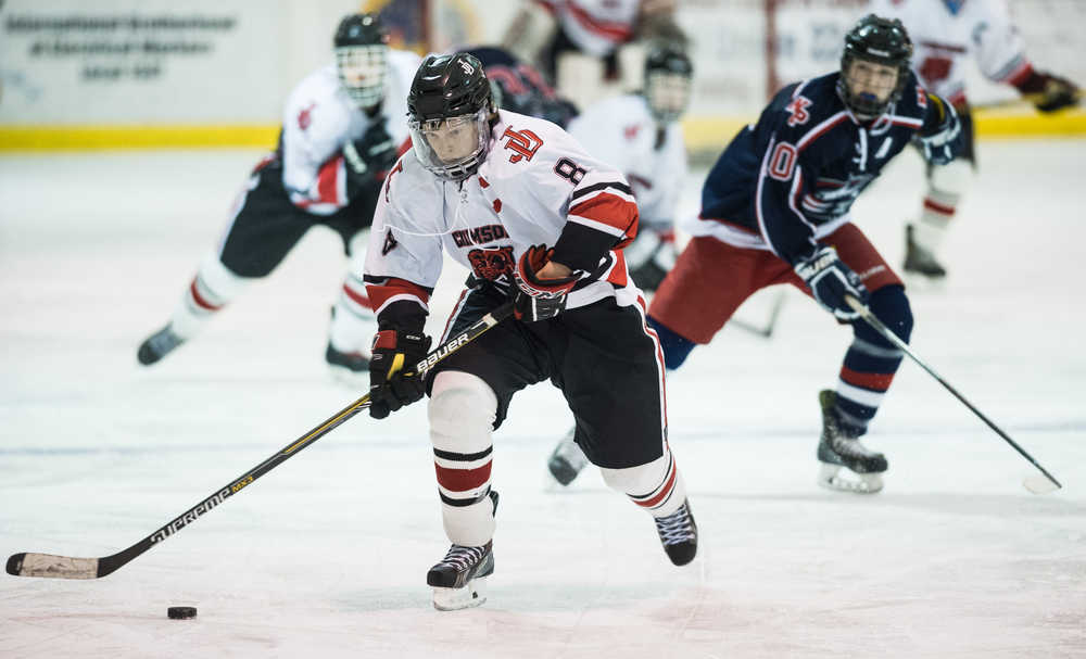 Juneau-Douglas' Zach Hebert moves the puck against North Pole in JDHS's final home game of the season on Friday.
