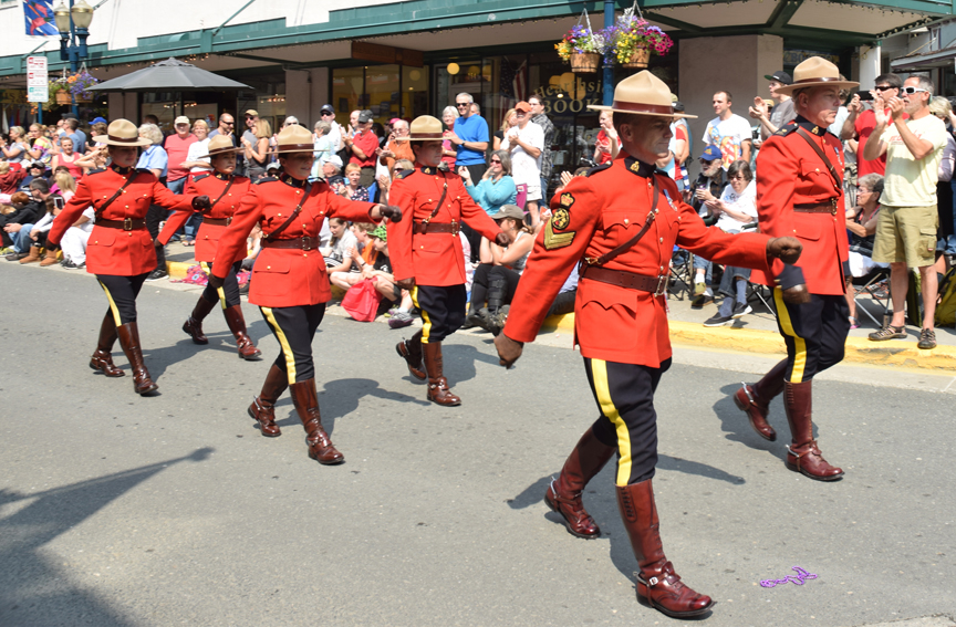 A contingent of Royal Canadian Mounted Police march down Front Street on Saturday, July 4, 2015. A group from Whitehorse participated in Juneau's Fourth of July parade as part of Juneau's Sister City project.
