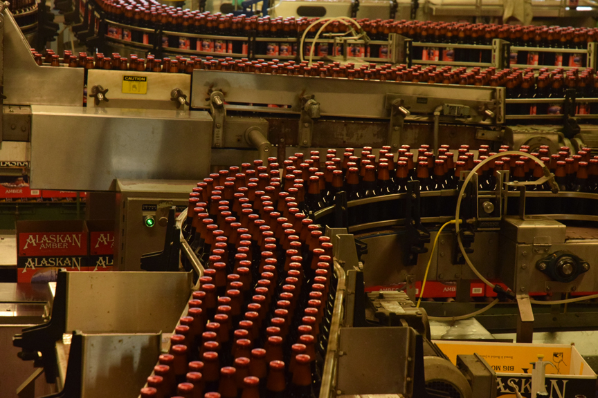 Bottles of Alaskan Amber beer roll along the bottling line at the Alaskan Brewing Company on July 7, 2015.