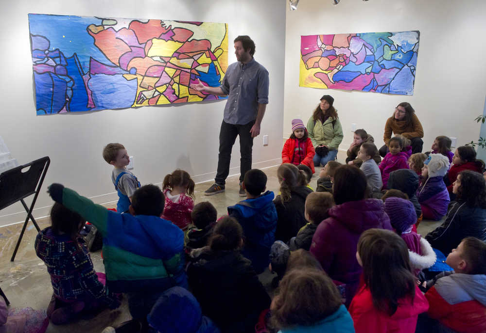 Brandon Howard, artistic coordinator for The Canvas, speaks to Harborview Elementary School kindergarteners as they see their work displayed in the gallery on Monday. About 50 students in teachers' Elisabeth Hauser and Maura Selenak classes made overlapping traces of their outlined bodies and then painted them with a mixture of primary colors. The work was an exercise in working together.