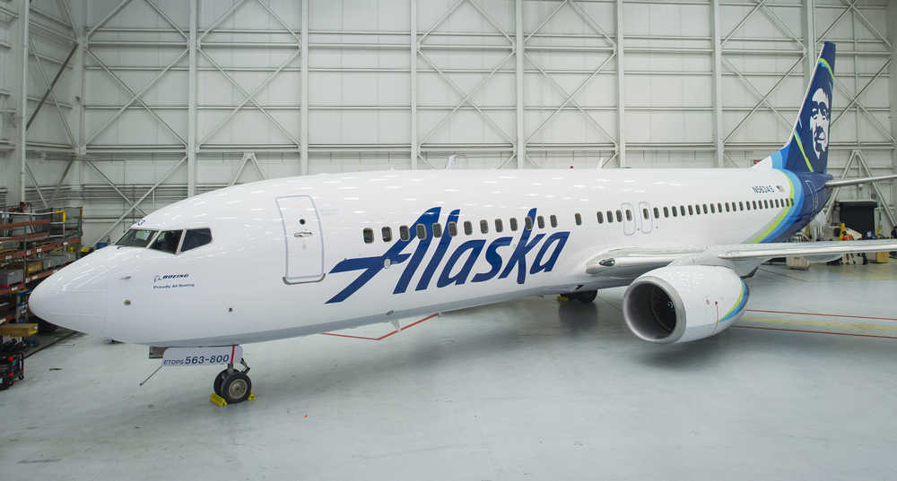 An Alaska Airlines 737-800, newly painted in the airline's 2016 refreshed brand, is ready to be revealed at the airline's maintenance hangar in SeaTac, Washington on Monday.