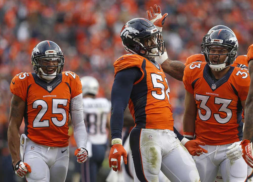 Denver Broncos outside linebacker Von Miller is congratulated by his teammates after a play during the AFC Championship game between the Denver Broncos and the New England Patriots on Sunday.