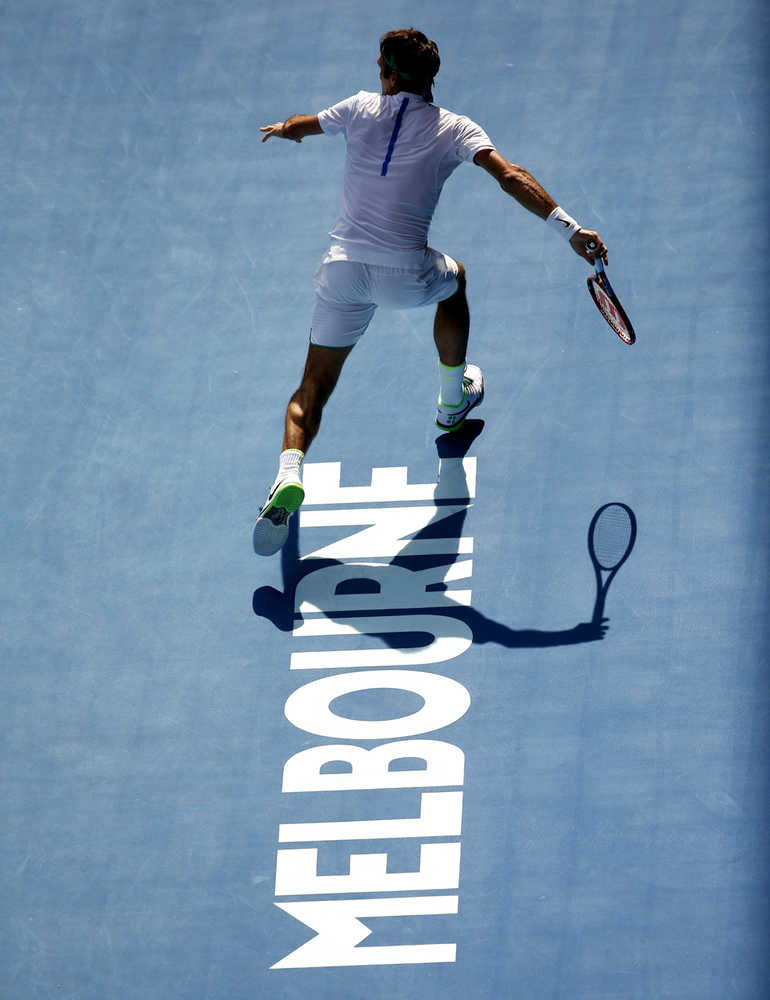 Roger Federer of Switzerland looks to play a forehand return to Tomas Berdych of the Czech Republic during their quarterfinal match at the Australian Open tennis championships in Melbourne on Tuesday.