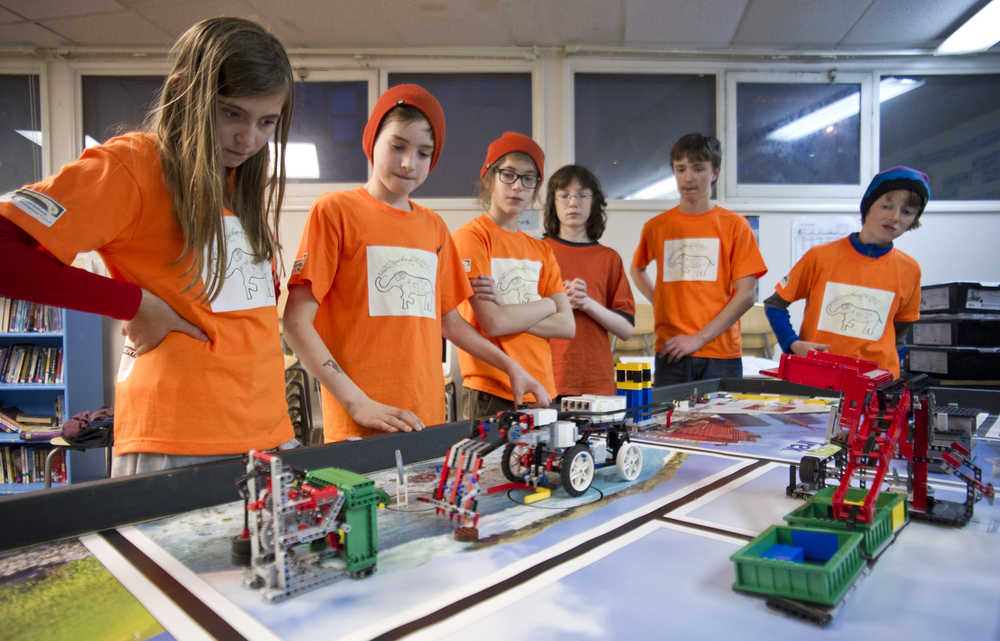 Nakenna Kotlarov, left, Finn Morley, Ambrose Bucy, Toby Minick, Zander Kotlarov and Aaron Blust watch their Lego robot perform a task during  practice at Juneau Charter Community School on Tuesday. The team won the regional tournament in Juneau and went on to place second in the state tournament in Anchorage.