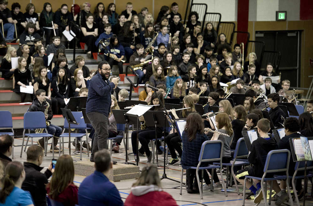 Artist-in-residence Edward Littlefield directs Floyd Dryden Middle School music students during an assembly on Friday. 'Telling Our Stories: Voices on the Land' is a residency sponsored by Sealaska Heritage Institute that allowed Littlefield to explore culture and music with over 180 students during the three week program.