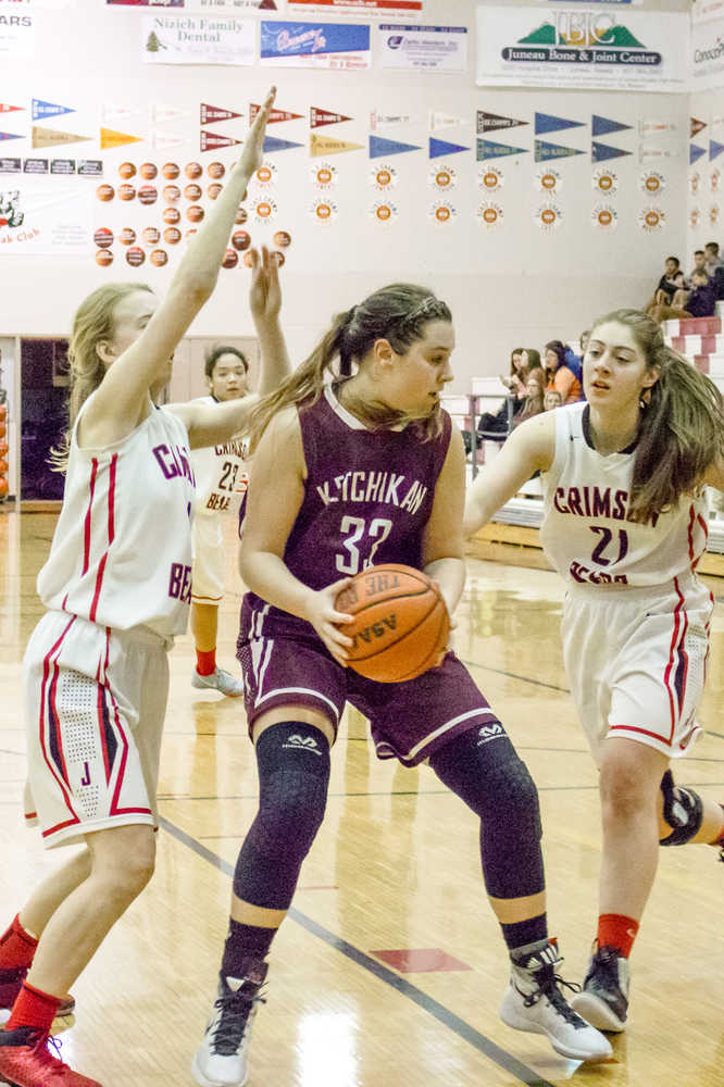 Ketchikan's Eliah Anderson does her best to keep her ball from the Crimson Bears on Friday night.