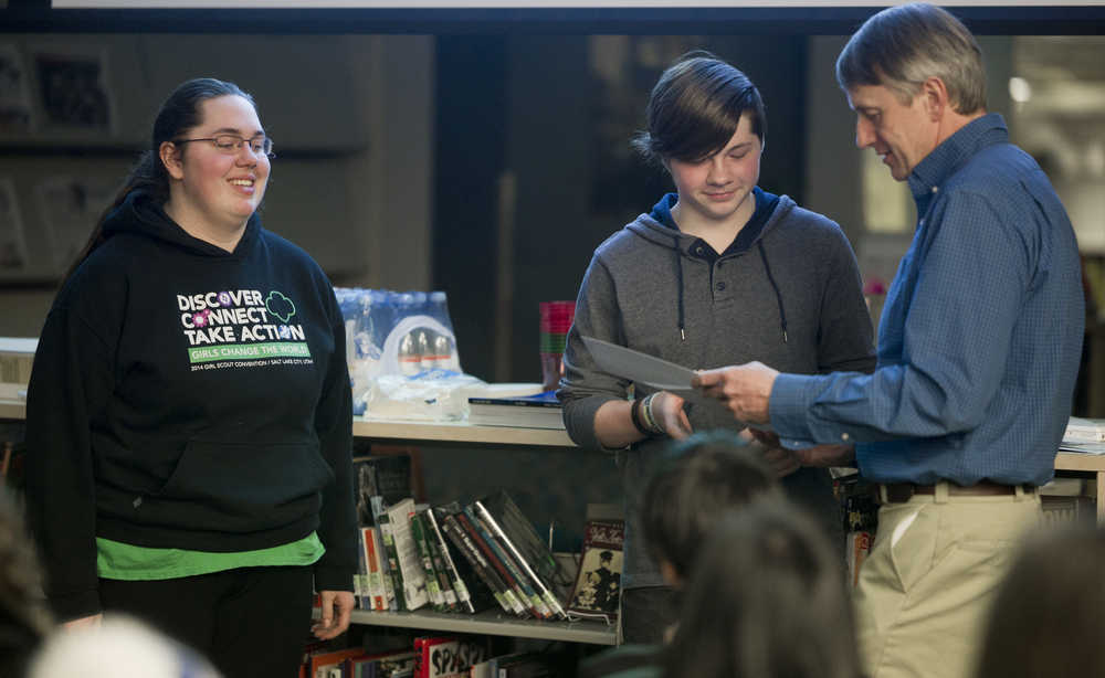 Jordan Cooper, left, and Brady Allio receive their first-place certificates in videography from Roger Healy for the Jan Neimeyer iDida Photography and Video Contest at Thunder Mountain High School on Thursday. Healy is the husband of Neimeyer, a local art teacher who died in August 2013.