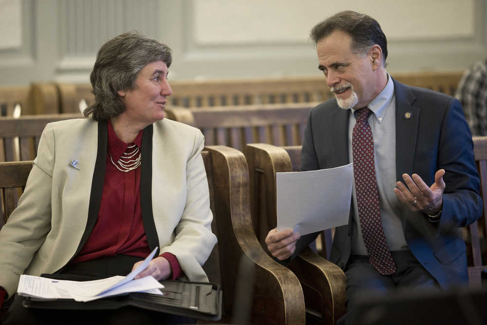 Sen. Peter Micciche, R-Soldotna, speaks with Pat Pitney, Director of the Office of Management and Budget, before a Senate Finance Committee meeting at the Capitol on Monday. Pitney was continuing her budget overview to the committee showing the reduction of state positions.