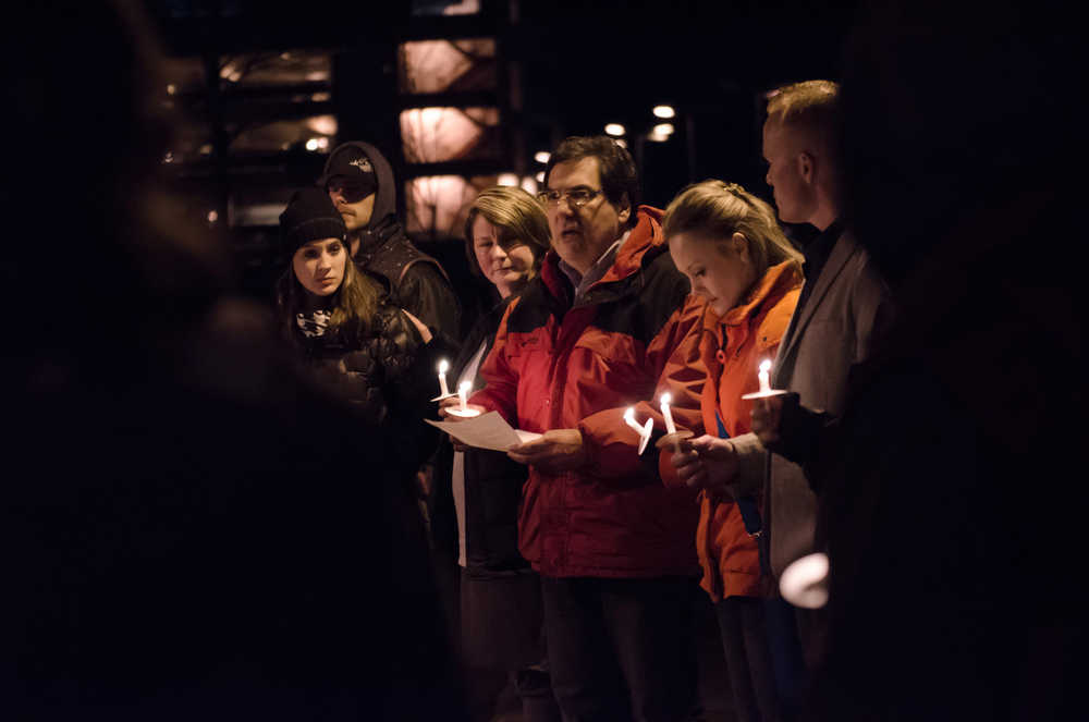Carlton Smith reads a few words to those to those who attended NCADD's Candlelight Vigil Saturday night at Marine Park.