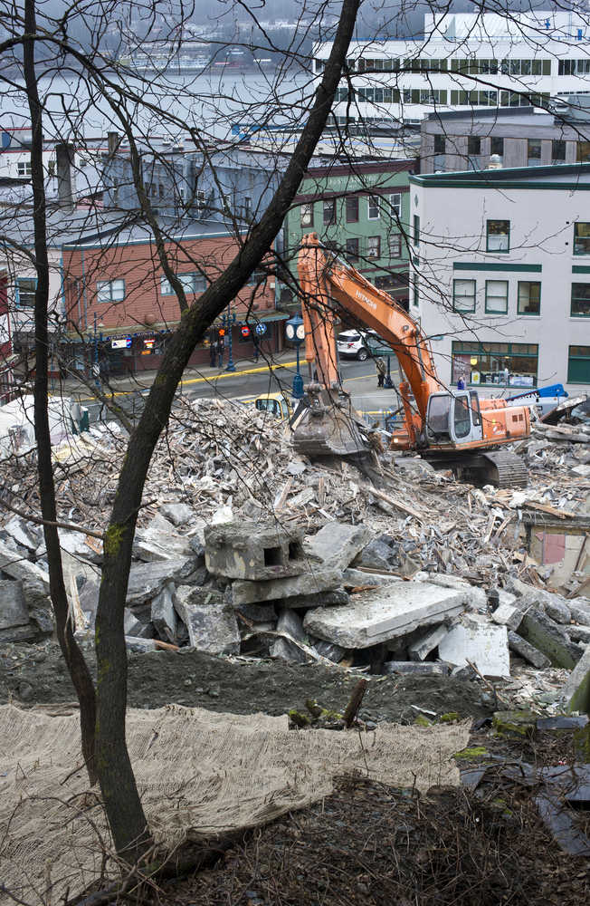 An excavator sifts through the rubble that was the Gastineau Apartments as seen from Gastineau Avenue on Tuesday.