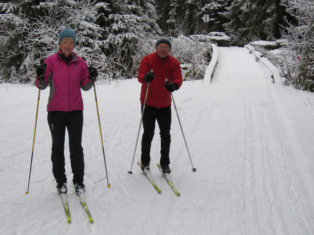 Chris Thomas, left, and Don Thomas, right, wait to ski Montana Creek Trail. The microclimate of the area and the openness of the trail means it stays open when other trails close. As of Wednesday morning, it was the only trail Juneau Nordic Ski Club was grooming, though that could change, especially out the road, if Juneau keeps getting snow at night this week.