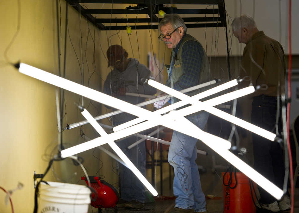 Steve Davis, center, volunteers with Bing Carrillo, left, and Joe Carlson on Thursday at the Juneau Arts & Culture Center to build creative lighting for the Wearable Art Extravaganza to be held Saturday and Sunday, Feb. 13-14. Saturday's show is sold out and as of Thursday 130 tickets remain for Sunday's show. According to Nancy DeCherney, executive director for the Juneau Arts and Humanities Council, volunteers are still needed.