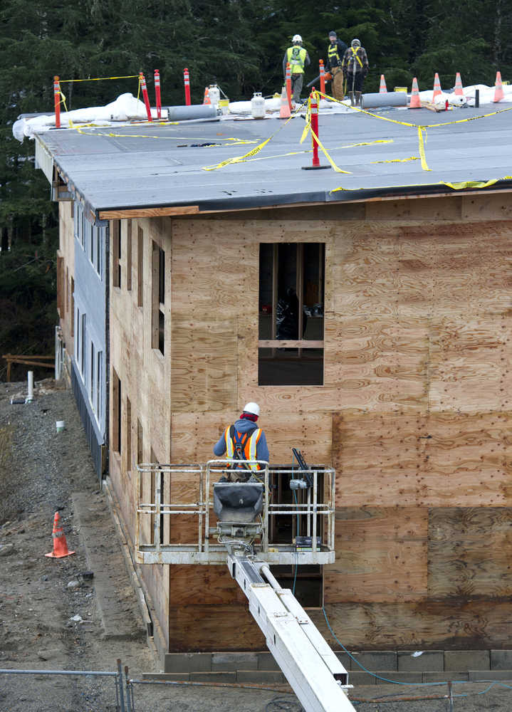 Coogan Construction employees work on a new building in the Island Hills Apartments complex located in West Juneau on Cordova Street on Friday. The complex will hold a total of 72 two-bedroom units when completed in June 2017.