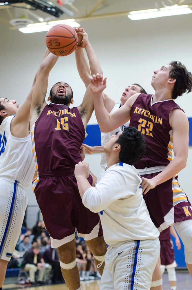 Kayhi's Mo Bullock fights for the rebound against Thunder Mountains' Mahina Toutiolepo, left, and Finn Collins, back, during their game Friday night at TMHS. Ketchikan won 76-65.