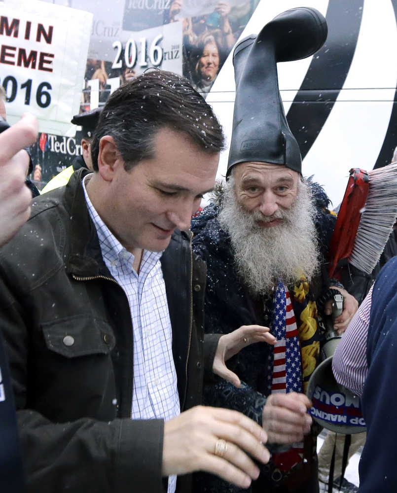 Democratic presidential candidate, Vermin Supreme (with beard) tries to engage with Republican presidential candidate, Sen. Ted Cruz, R-Texas, as he walks to his bus after a campaign event, Monday, Feb. 8, 2016, in Manchester, N.H. (AP Photo/Elise Amendola)