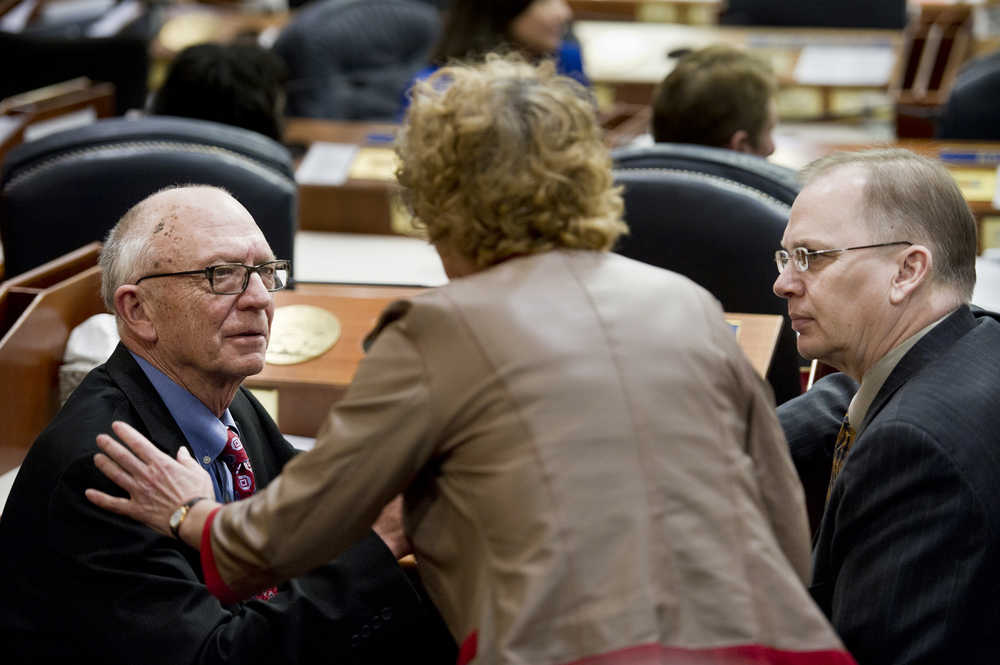 Rep. Gabrielle LeDoux, R-Anchorage, speaks with House Finance Co-Chairs Rep. Steve Thompson, R-Fairbanks, left, and Rep. Mark Neuman, R-Big Lake, in the House of Representatives on Monday as they discuss changing their governing rules to focus on the budget crisis.