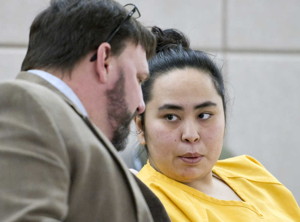 Nora E. Thomas, 28, speaks to Assistant Public Defender Eric Hedland during her arraignment in Juneau Superior Court on Tuesday for the death of 50-year-old Christopher K. Kenney in 2014.