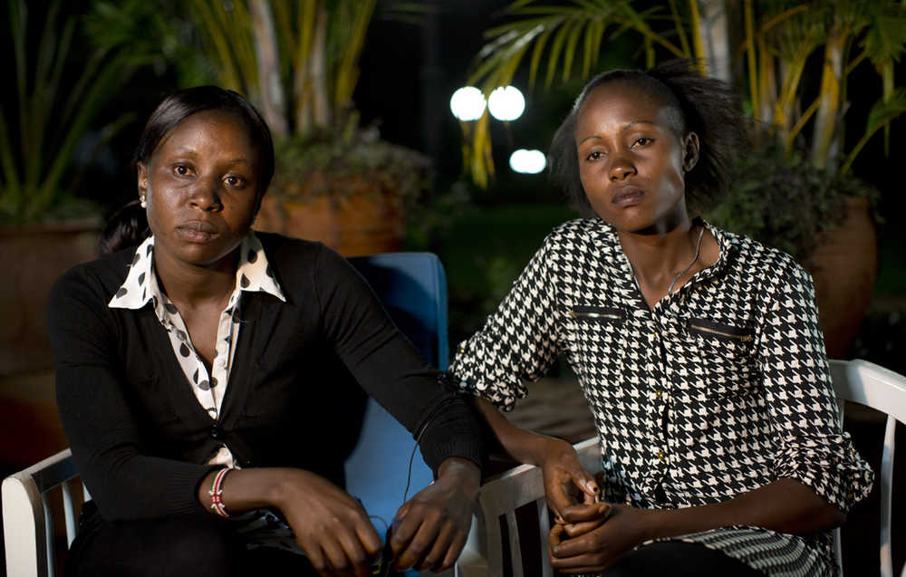 In this photo taken Feb. 4, Joy Sakari, a 400-meter runner, left, and Francisca Koki Manunga, a hurdler, right, who were both banned for doping at the 2015 world championships, speak exclusively to The Associated Press in the town of Embu, Kenya.