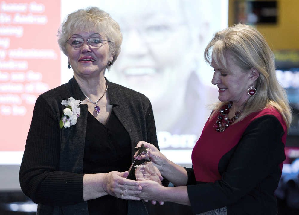 Laraine Derr, left, is presented with the American Association of Retired Persons' Andrus Community Service Award by First Lady Donna Walker during a luncheon at TK Maguire's on Wednesday. The award is the AARP's most prestigious state volunteer award for community service.