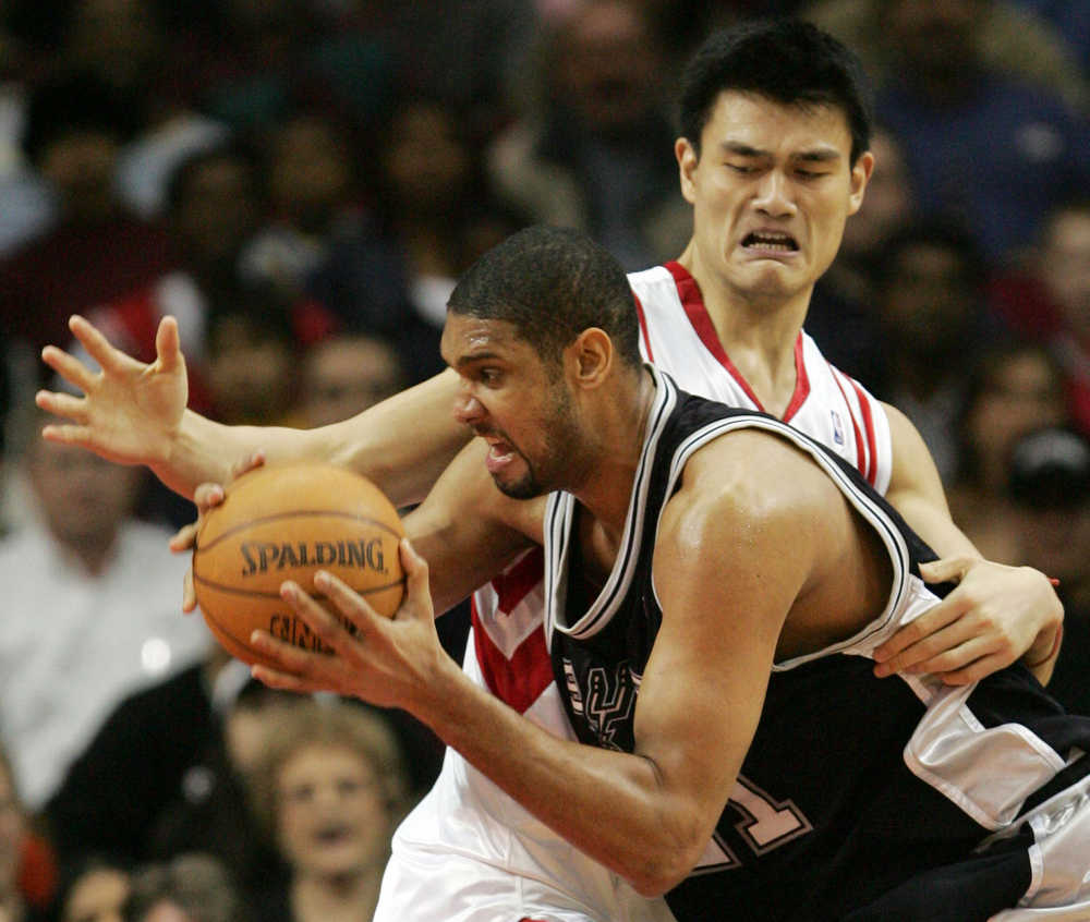 In this Jan. 15, 2005 photo, San Antonio Spurs' Tim Duncan works to get by Houston Rockets' Yao Ming during the fourth quarter of an NBA game in Houston. This year's Hall of Fame class includes a star-studded field of potential finalists, including Shaquille O'Neal, Yao Ming and Allen Iverson. That trio should be a lock to get in.