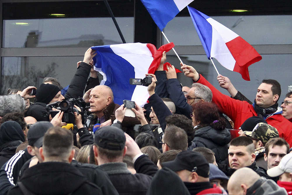 In this Feb 6 photo, far-right activists and supporters of the group Patriotic Europeans against the Islamization of the West demonstrate with former French Gen. Christian Piquemal, center left, in Calais.
