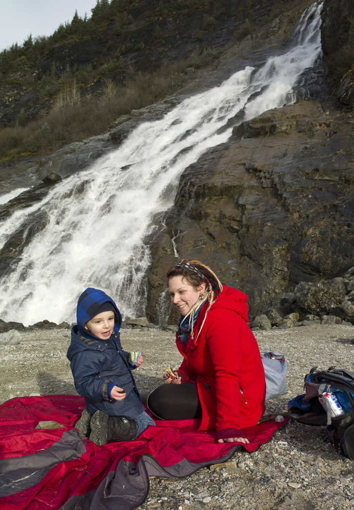 Cora Petty and her son, Quinn, 2, picnic at the base of Nugget Falls on Monday.