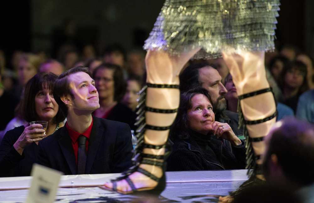 Audience members watch as models display artist KD Roope's "Clipped Counterparts" made of paper clips, binder clips, mercury glass and wire during the Wearable Art Extravaganza 2016 at Centennial Hall on Sunday, Feb. 14, 2016.