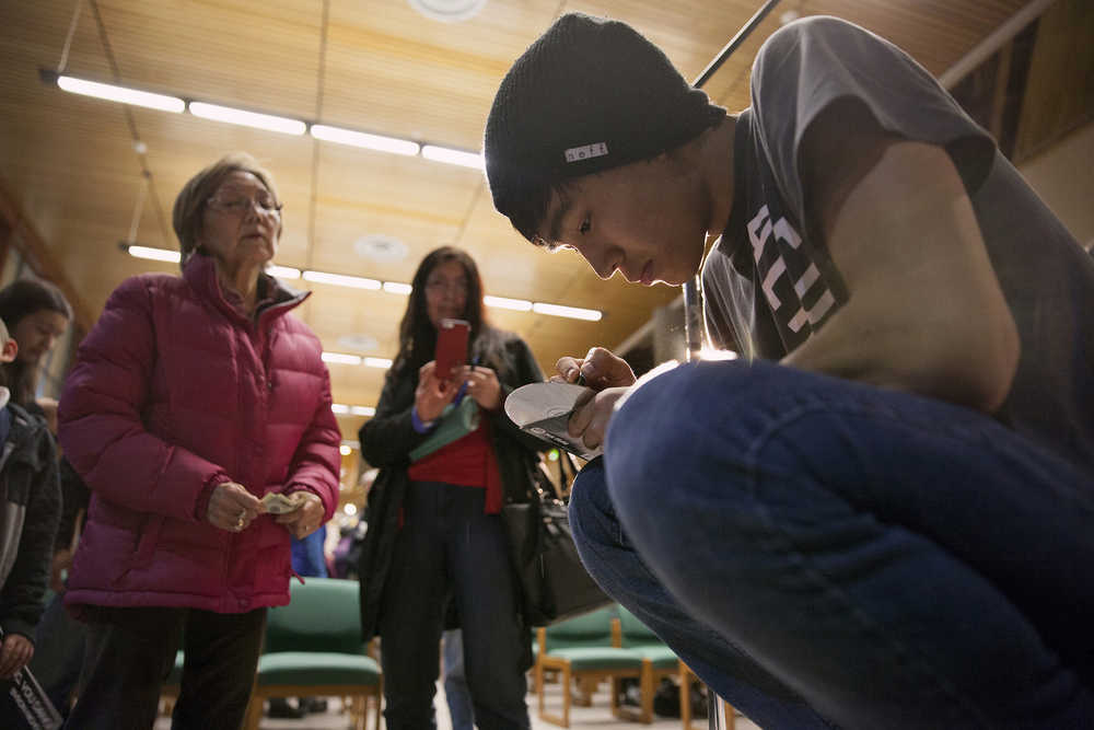 In this Feb. 12 photo, performer Byron Nicholai signs his album for fans after a performance at the University of Alaska Southeast in Juneau.