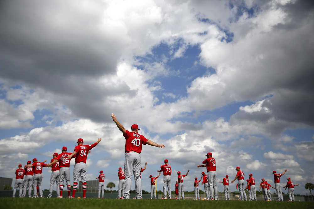 Members of the St. Louis Cardinals stretch at the start of spring training on Thursday in Jupiter, Florida.