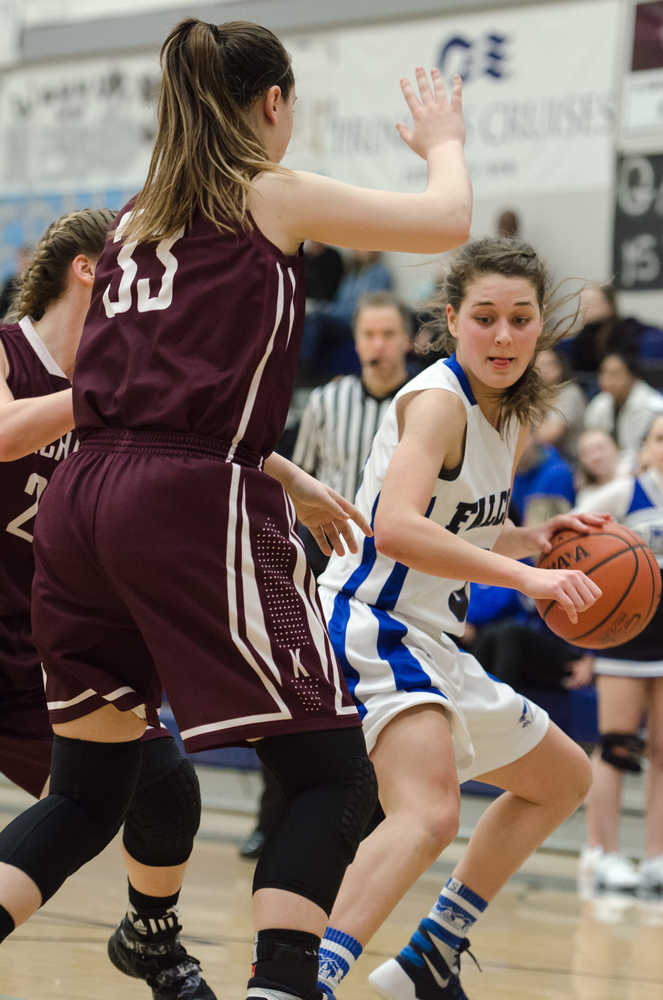 Thunder Mountain's Ava Tompkins looks to drive against Ketchikan's Courtney Kemble, front, and Alexis Biggerstaff, back, during their game Friday night at TMHS. Ketchikan won 53-37.