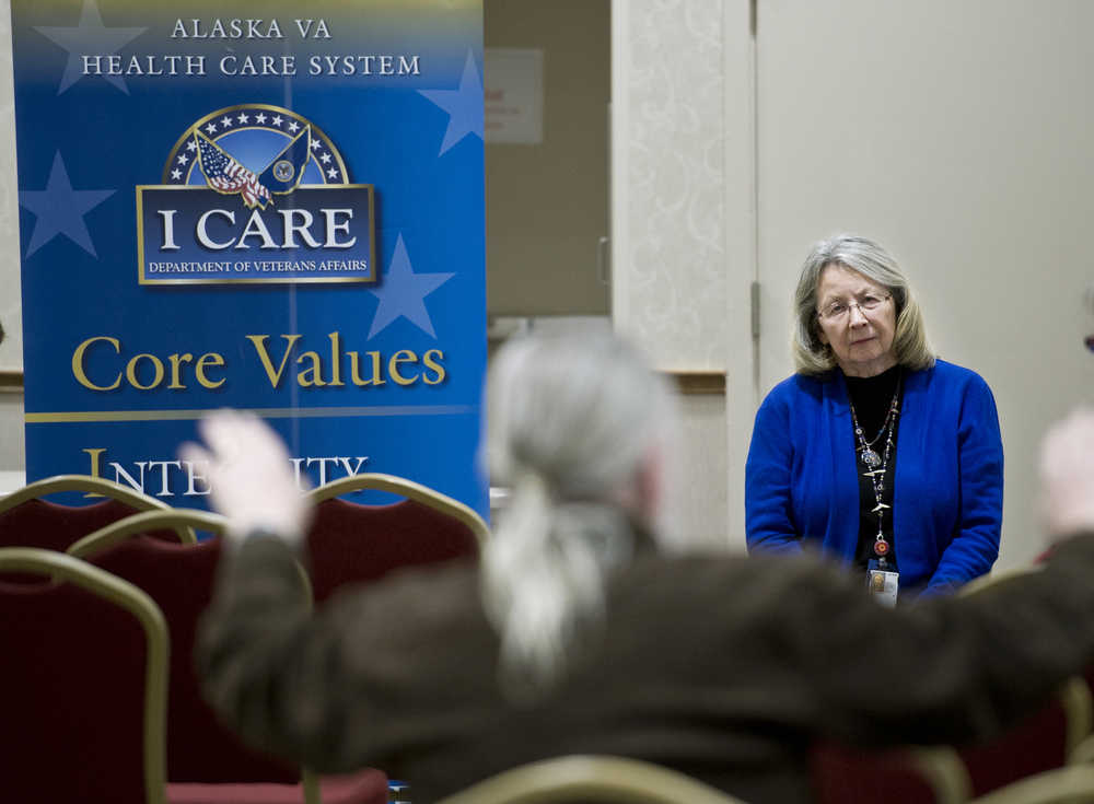 Linda Boyle, the interim director of the Alaska Veterans Affairs system, listens to veteran James Helfinstine describes failures in the Veterans Affairs medical system during a town hall meeting in the Elizabeth Peratrovich Hall on Monday.