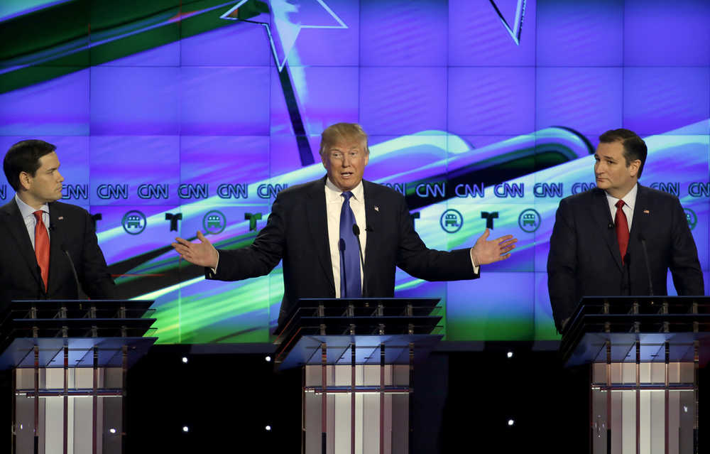 Businessman Donald Trump, center, speaks as  Sen. Marco Rubio, R-Fla., left and Ted Cruz, R-Texas look on during a Republican presidential primary debate at The University of Houston on Thursday.