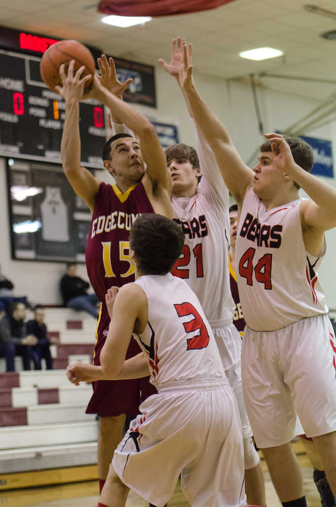 Mt. Edgecumbe's John Housler shoots against Juneau-Douglas's Treyson Ramos, front, Hunter Hickok, right, and Bryce Swofford, back, during their game Thursday night at JDHS. Juneau wins 70-63.