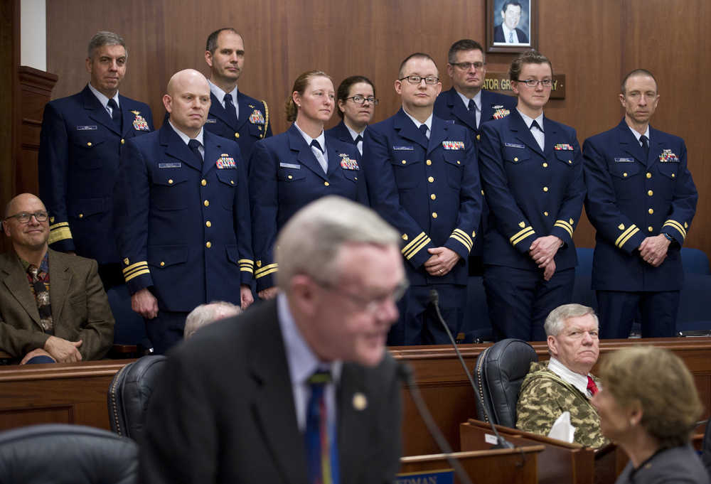 Leadership of the U.S. Coast Guard's 17th District stand in the Senate chambers gallery, including Commander Rear Admiral Daniel B. Abel, standing left, as Sen. Dennis Egan, D-Juneau, introduces them at the start of Friday's session.