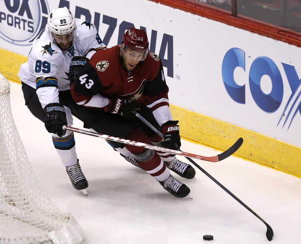FILE - In this Oct. 2, 2015, file photo, Arizona Coyotes left wing Matthias Plachta (43) shields San Jose Sharks left wing Barclay Goodrow in the third period during a preseason NHL hockey game, in Glendale, Ariz. The Arizona Coyotes and Pittsburgh Penguins kicked off NHL trade deadline day by making a small deal over breakfast, Monday, Fed. 29, 2016. A source told The Associated Press that the Coyotes have acquired winger Sergei Plotnikov from the Penguins in exchange for prospect Matthias Plachta and a conditional seventh-round pick in 2017. The source spoke on condition of anonymity because the teams hadn't announced the deals. (AP Photo/Rick Scuteri, File)