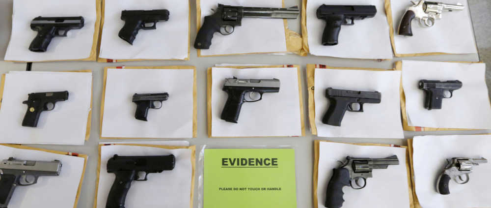 In this July 7, 2014 photo, Chicago police display some of the thousands of illegal firearms they confiscated during the year. At a news conference Tuesday, Chicago police said there have been about twice as many homicides and shootings so far this year in Chicago as compared to the same period in 2015, but the number of illegal guns seized has dropped.